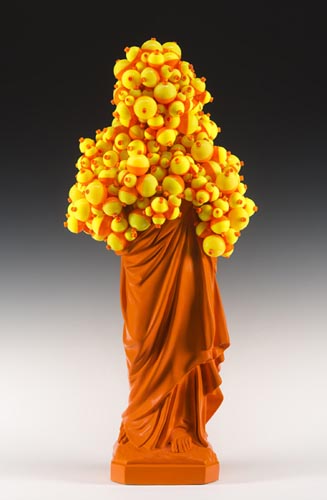 <b>Float (orange), 2012</b><br>34" x 15" x 10"<br>re-purposed resin figure, plastic floats, paint, plaster and steel